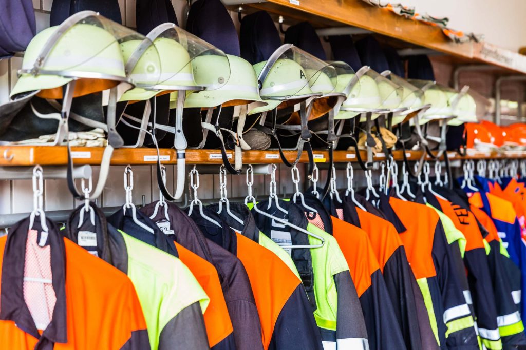 Helmets and uniforms in locker rooms of fire fighters